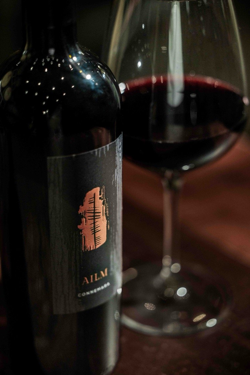 Ailm Connemara red wine bottle and glass